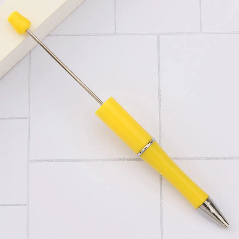 Ballpoint pen with colourful spinning plastic beads on barrel, shown in a gradient purple finish.