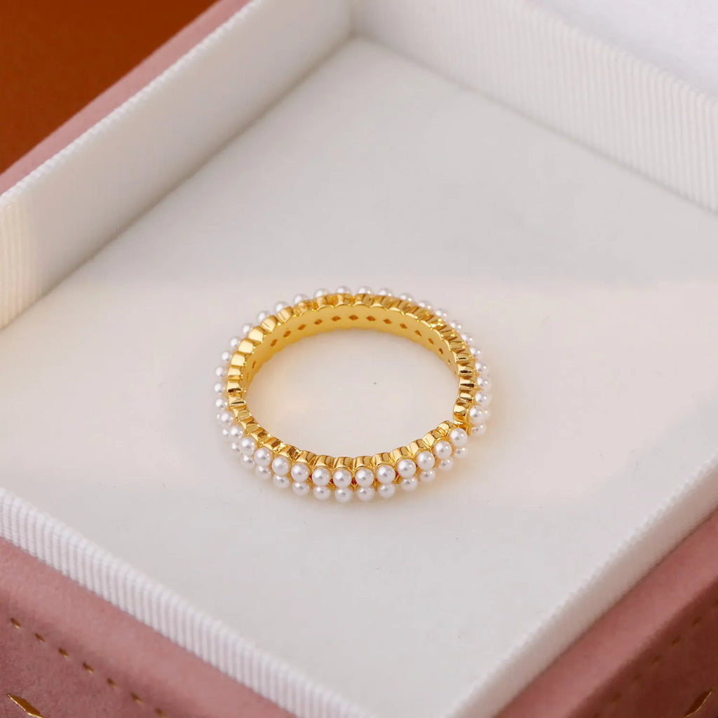 Gold coloured open mouth ring with geometry modelling and round design elements on copper base