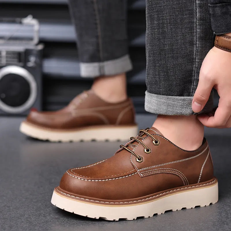 Men's black retro Martin boots with a low top, round toe, and non-slip rubber sole on a plain background.
