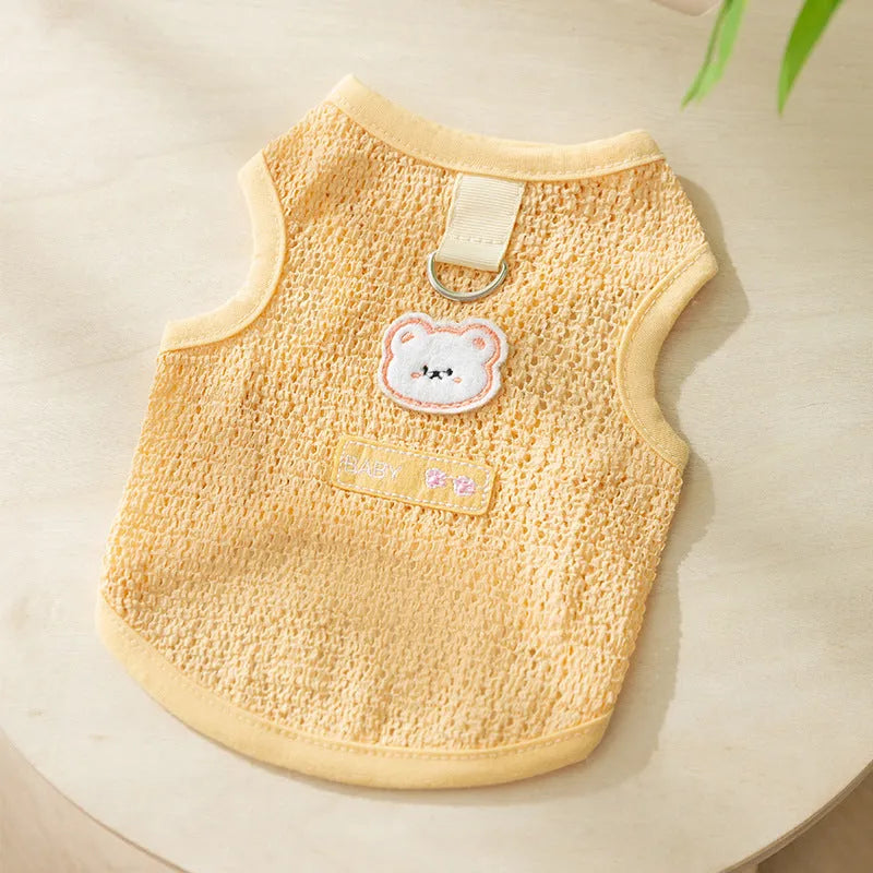 Cat wearing blue bear patch clothing with hollowed-out knitted fabric construction