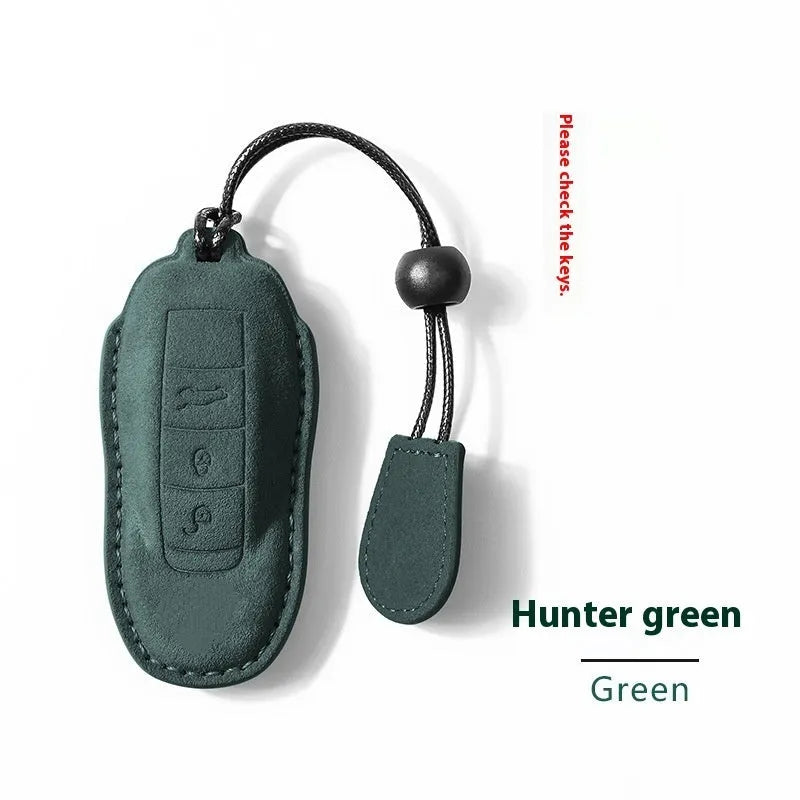 Suede car key cover in cement grey, dark green, light grey, and orange colour options