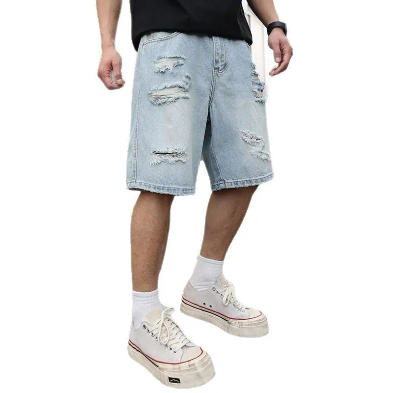 Light blue distressed denim shorts with ripped details, shown in a loose, straight-leg hip-hop style fit.