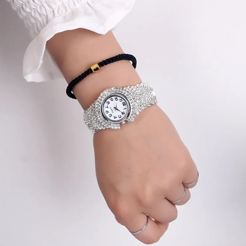 Women's 33mm quartz watch with circular dial, metal case, alloy strap, and open buckle