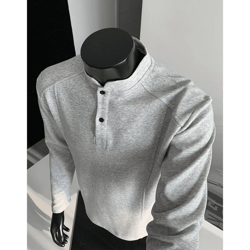 Men's loose fit cotton polo shirt with a stand-up collar and long sleeves in a solid colour.