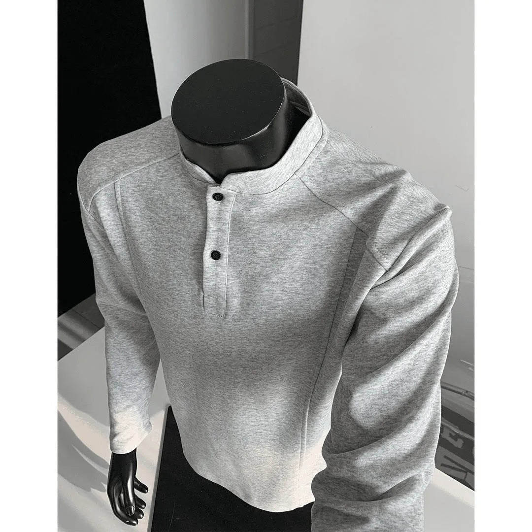 Men's loose fit cotton polo shirt with a stand-up collar and long sleeves in a solid colour.