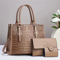 A burgundy PU leather three-piece bag set showing a crossbody bucket bag, a wallet, and a card holder.