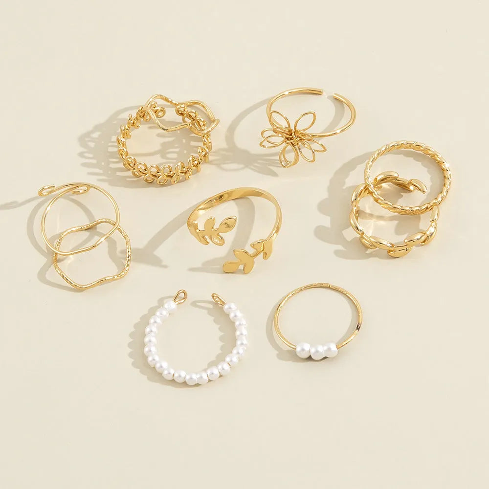Gold-coloured alloy ring with openwork flower design and glossy electroplated finish
