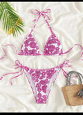Women's floral pattern halter swimsuit briefs in light blue on a mannequin.