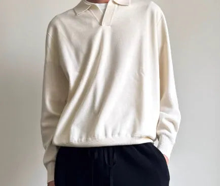 Men's navy blue loose fit wool polo sweater with a lapel collar on a hanger.