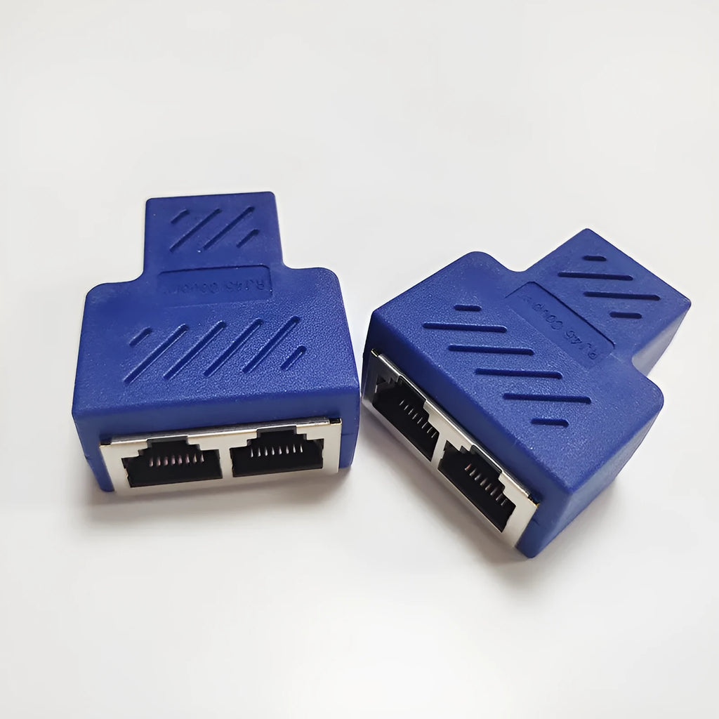 Two white RJ45 three-way network tee splitters on a table.