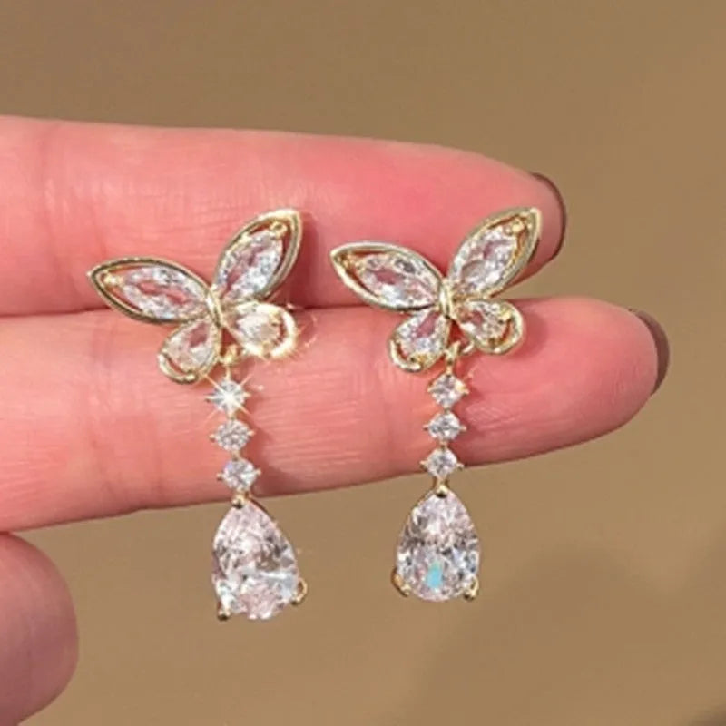 A pair of women's bow-shaped stud earrings with a platinum-coloured electroplated finish.