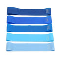 Set of five colour-coded TPE yoga tension straps laid out side by side, showing green, blue, yellow, red, and black options.