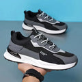 Men's colour block mesh lace-up running shoes in black, grey and white on a white background.