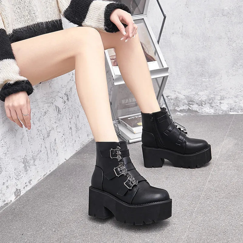 Black women's punk style short boots with bat buckle, thick heel, and side zipper.