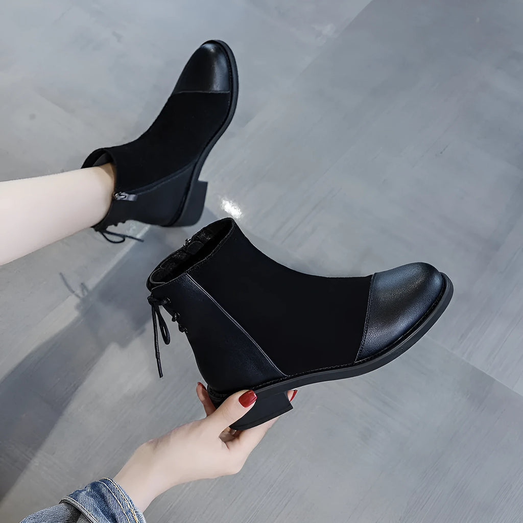 Black women's Martin Boots with knee-length design, side zip closure, and decorative bow detail