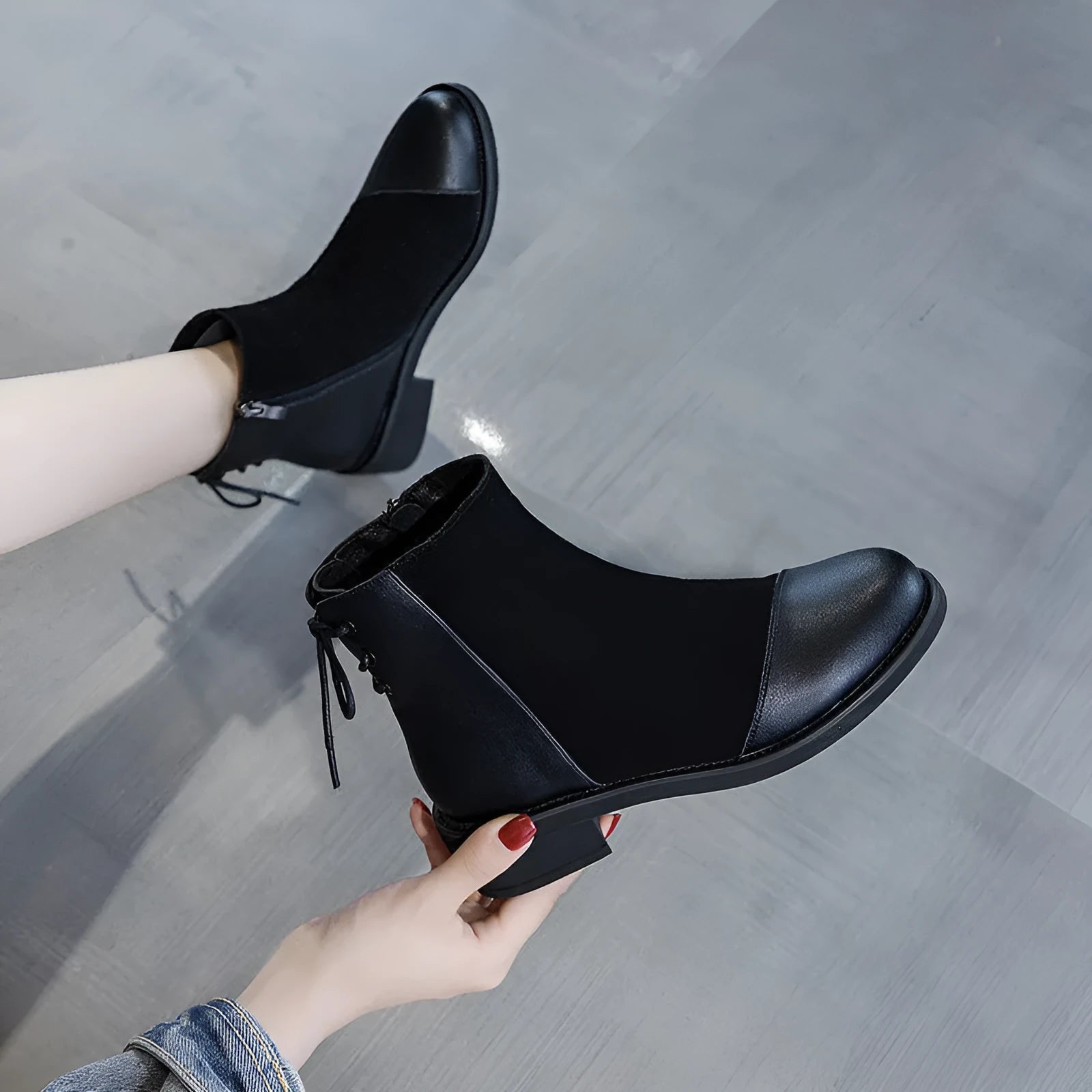 Black women's Martin Boots with knee-length design, side zip closure, and decorative bow detail