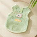 Cat wearing blue bear patch clothing with hollowed-out knitted fabric construction