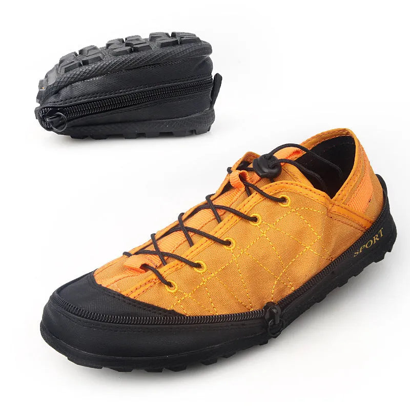 Orange portable folding outdoor shoe with side zipper and mesh upper on a grey background