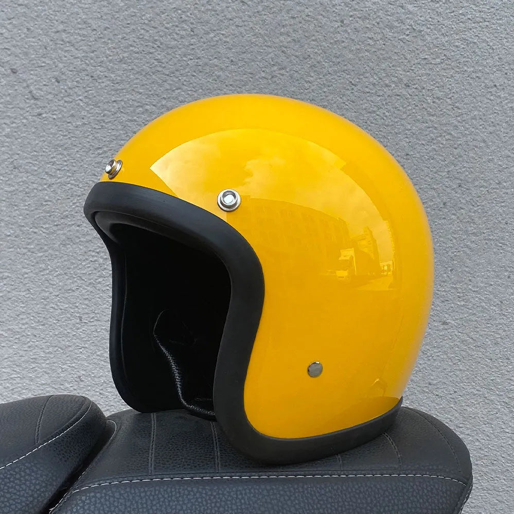 Retro-style half-shell motorcycle helmet in fibreglass, shown in a cement grey colour option.
