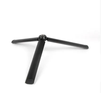 Black aluminium mobile phone tripod stabilizer with PTZ functionality on a table