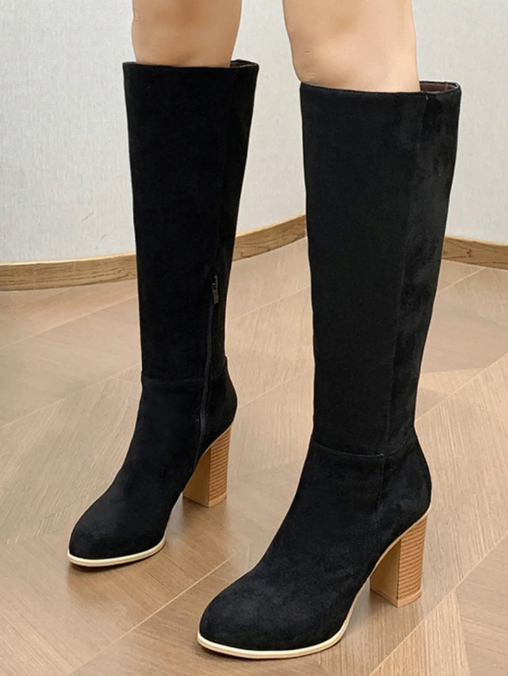 Black square toe high heel fashion boots for women on a white background.