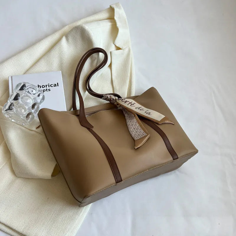 Large soft tote bag in bucket style with crossbody strap and sewing line detailing