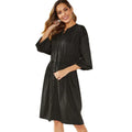 Women's loose elastic belt cinched short dress in solid black or red polyester with long sleeves and A-line skirt