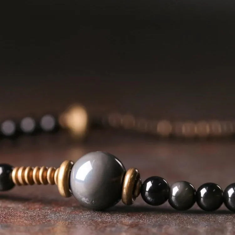Black geometric beaded bracelet with colourful multi-layered retro design and adjustable cord