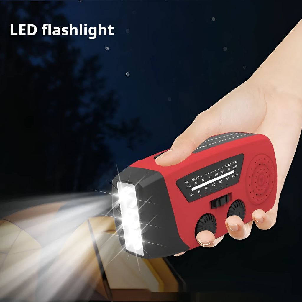Red rechargeable emergency hand torch with AM/FM radio and wrist strap for disaster preparedness