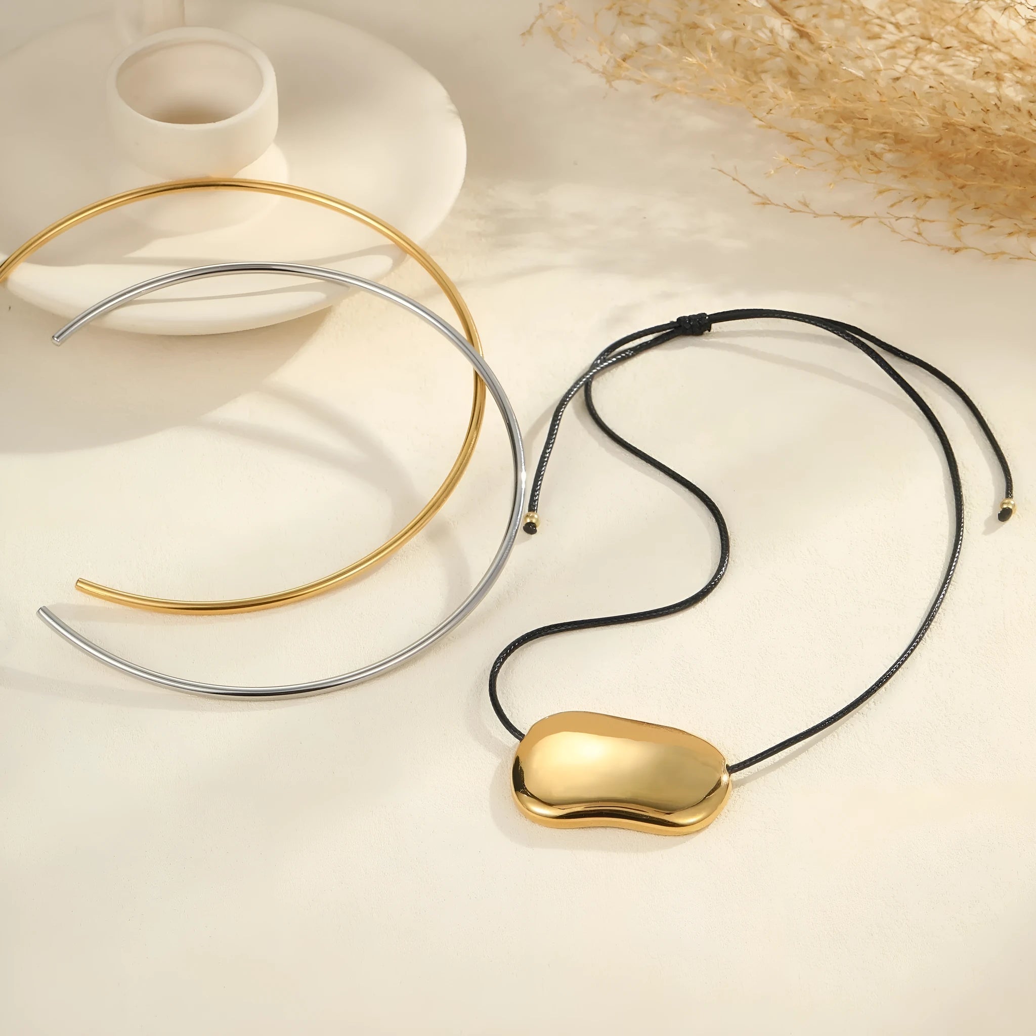 Men's stainless steel necklace with geometric pendant in gold or silver finish on adjustable chain