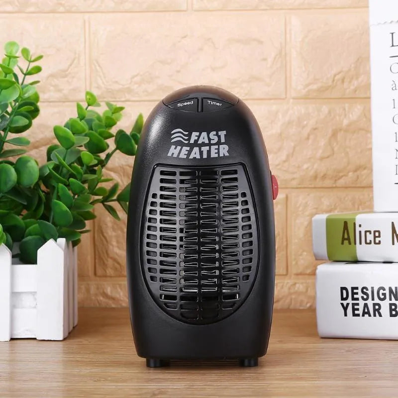Black mini ceramic electric heater with digital display and a rotating three-prong plug on a desk.