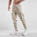 Men's loose cotton sports trousers with ankle tie closure and multiple pockets in solid colour