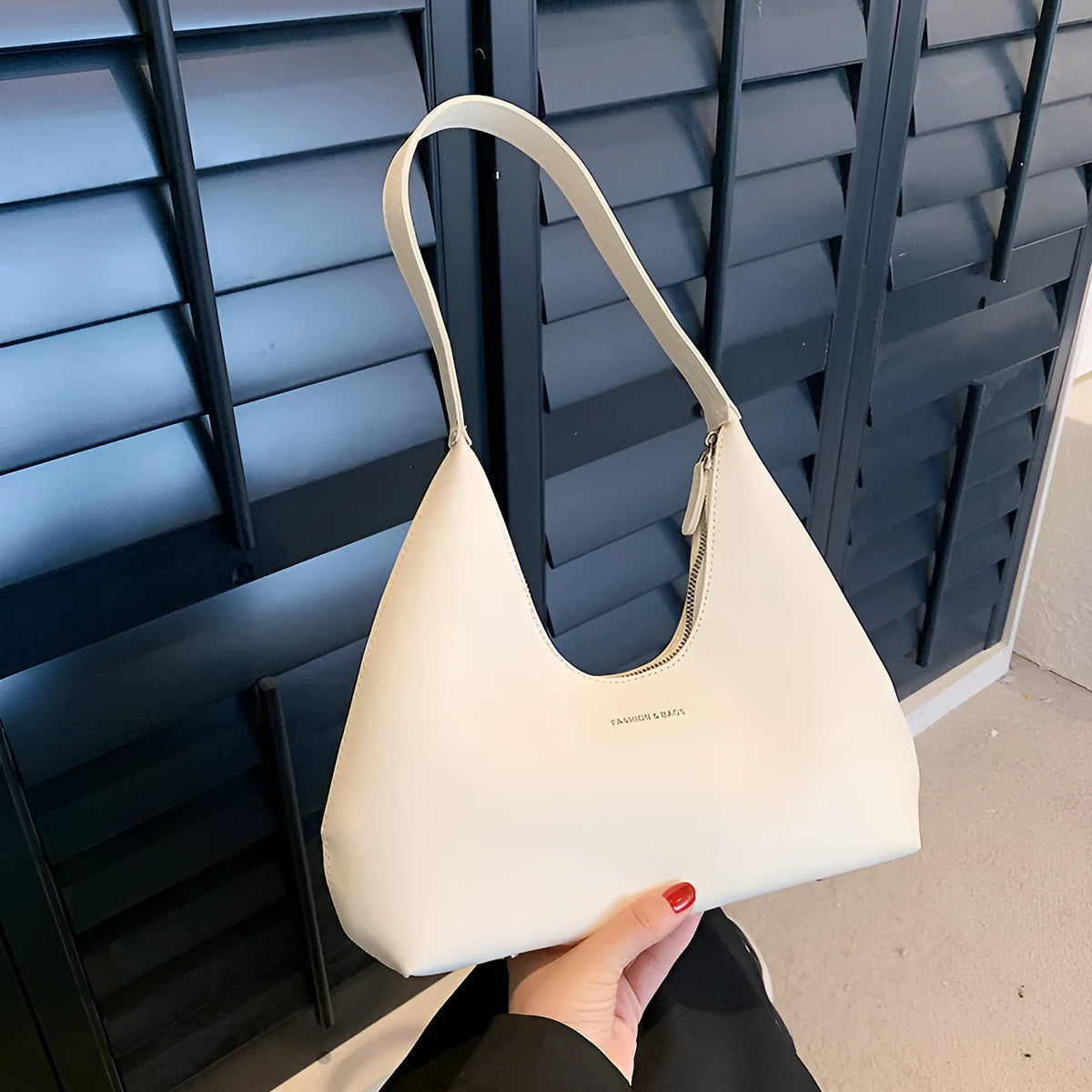 Retro style PU shoulder handbag in pillow shape with single strap and internal organisation pockets