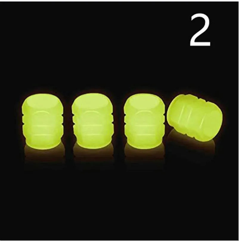 Set of luminous rubber tyre valve caps in assorted colours on a car wheel valve stem.