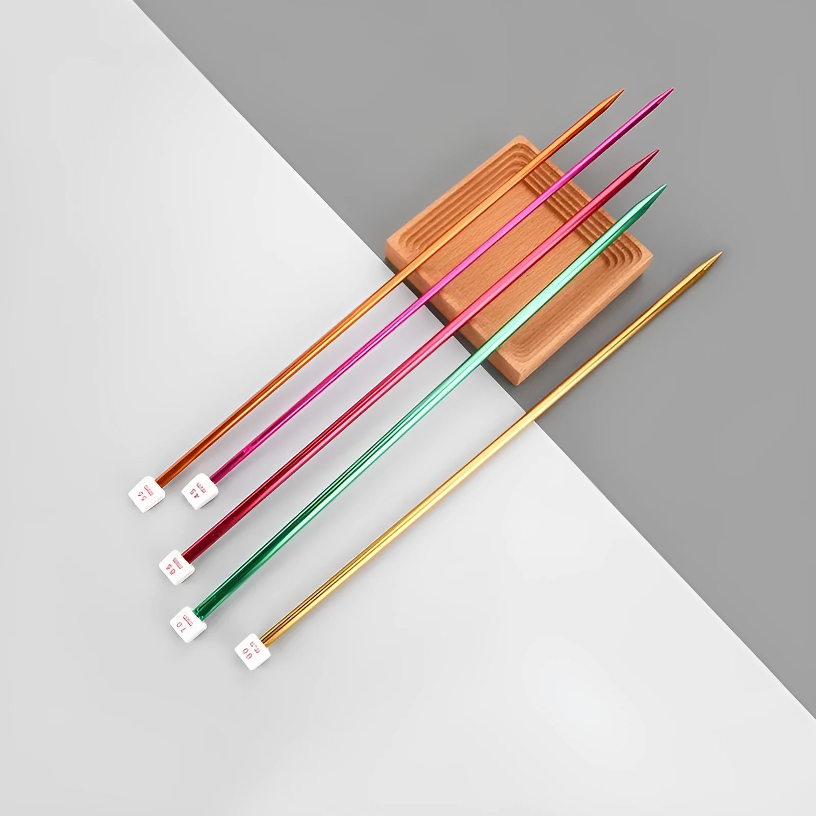 Lengthened crochet hook set showing multiple sizes with protective caps on ergonomic handles