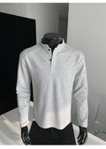 Men's loose fit cotton polo shirt with a stand-up collar and long sleeves in a solid colour.
