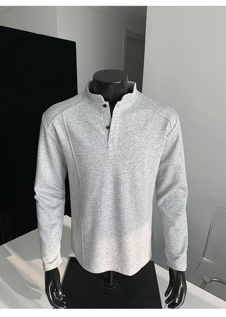 Men's loose fit cotton polo shirt with a stand-up collar and long sleeves in a solid colour.