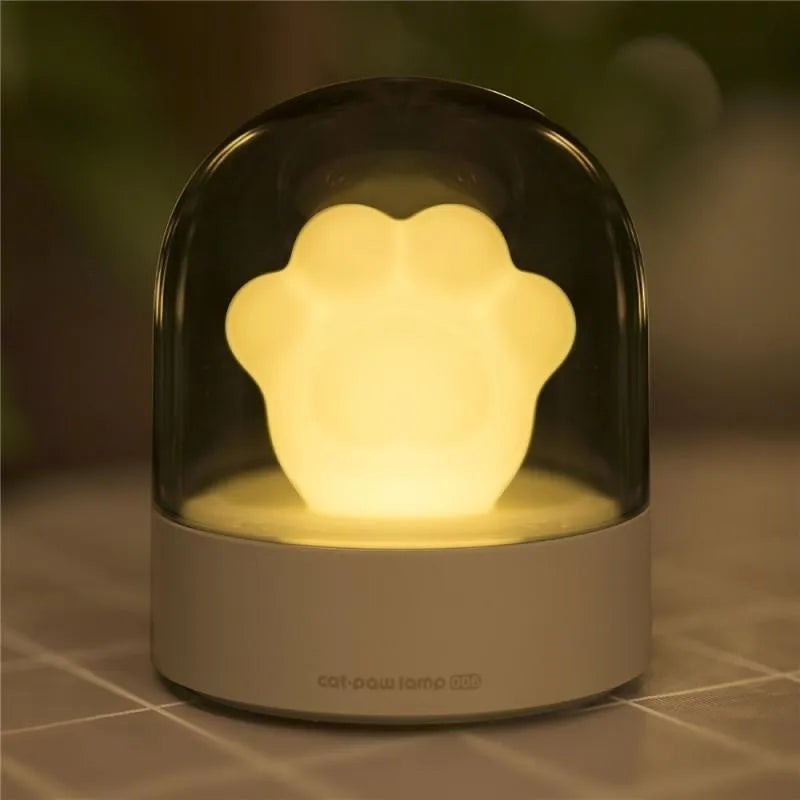 Grey cat paw shaped night light with USB charging cable and adjustable brightness controls