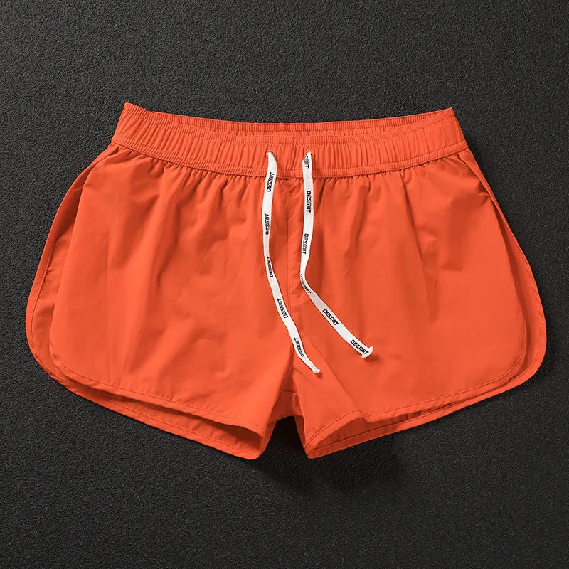 Men's loose beach surfing shorts in orange, fluorescent green, and black colors with elastic waistband