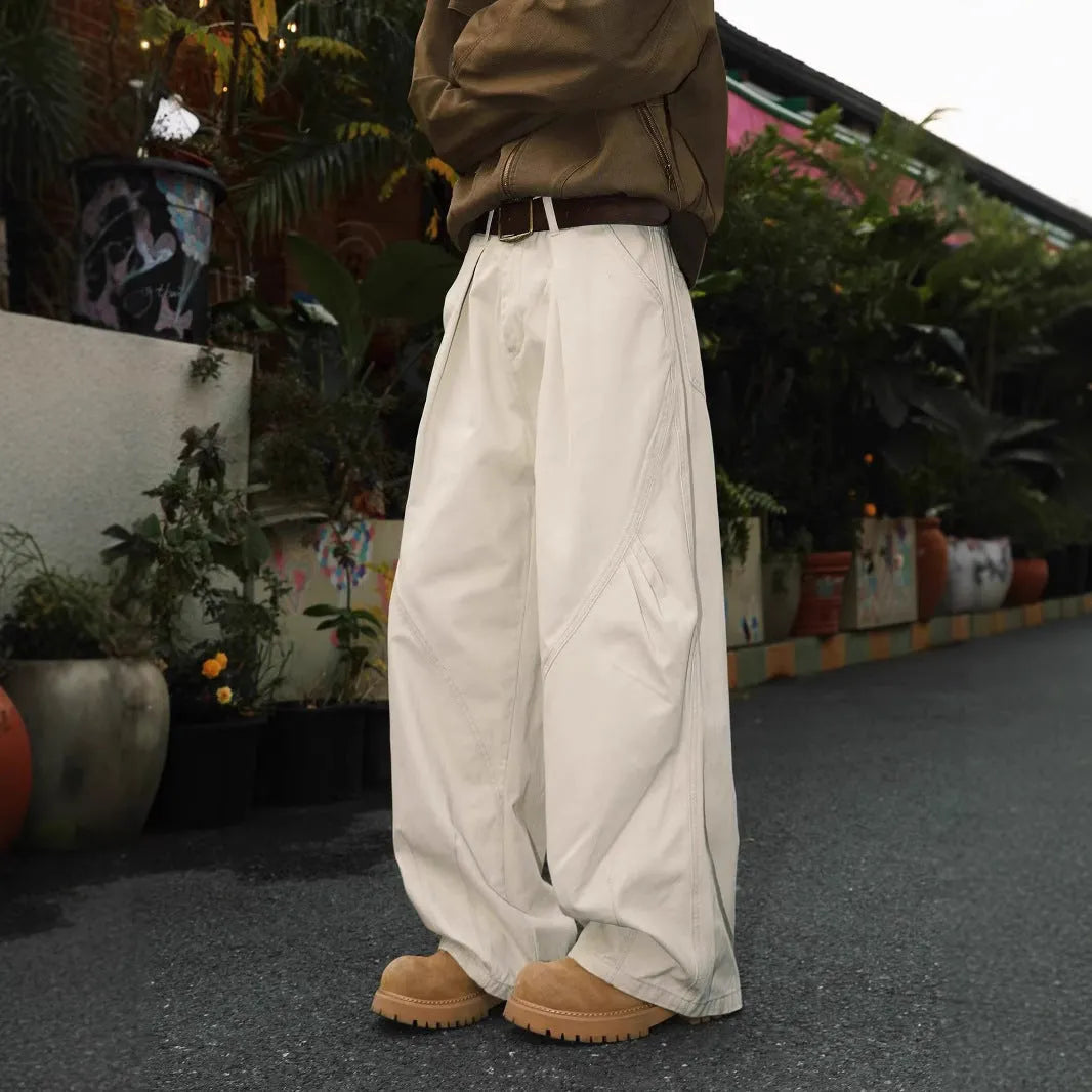 Men's apricot straight-leg loose fit trousers with elastic waist on a hanger.