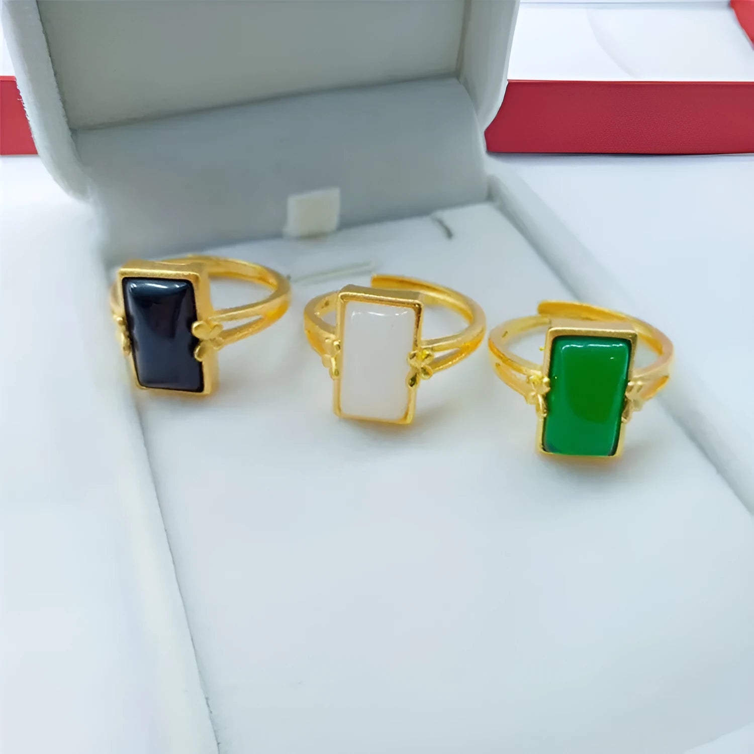 Adjustable brass electroplated ring with gold plating and embedded gemstones in black, green or white options