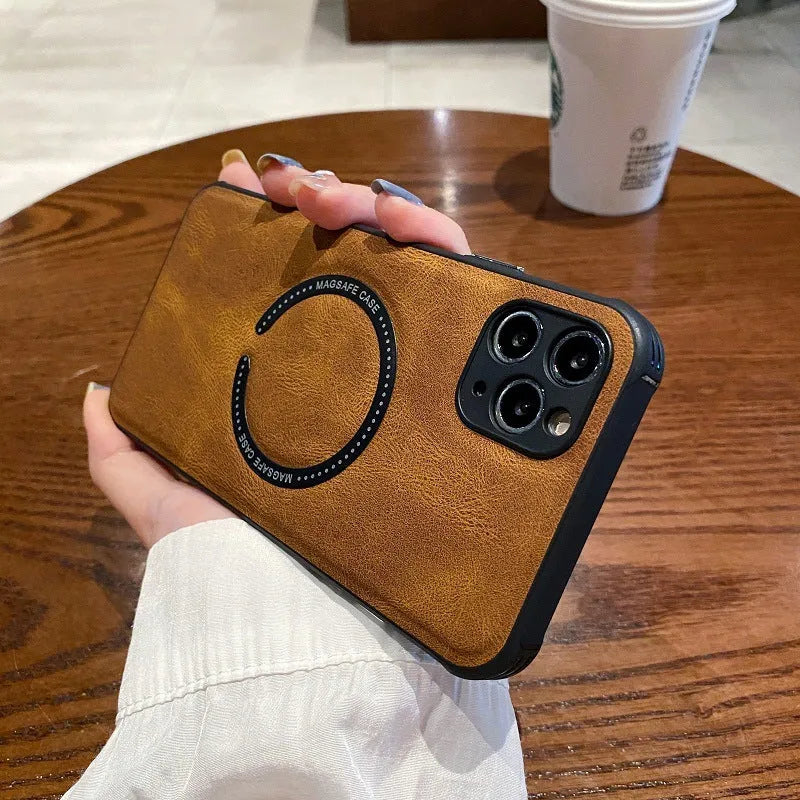 Black imitation leather magnetic charging case for Apple iPhone on a wireless charger.