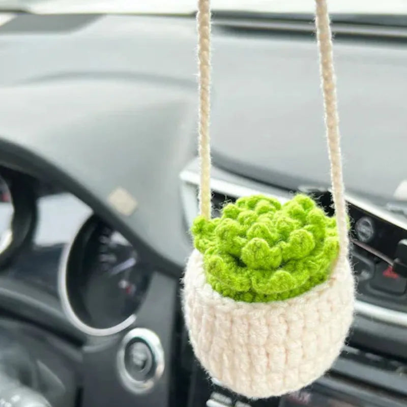 Green and white knitted wool car plant decoration with plastic base and hanging rope
