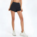 Nylon women's high-waist fitness shorts in black, shown on model for running or gym use.