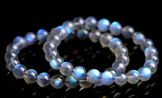 Natural cream body blue moonlight crystal bracelet shown in a simple unisex design on a wrist.