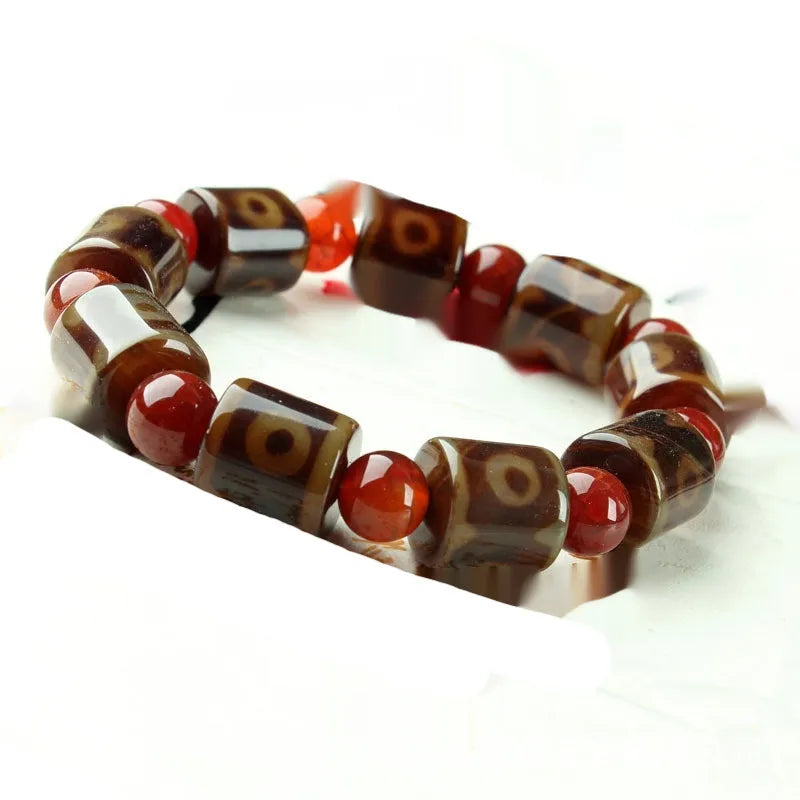 Distressed agate bracelet with traditional Tibetan dzi beads including three-eye and Nine Eyes designs.