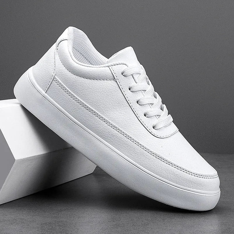 Women's white leather flat lace-up shoes on a solid background.