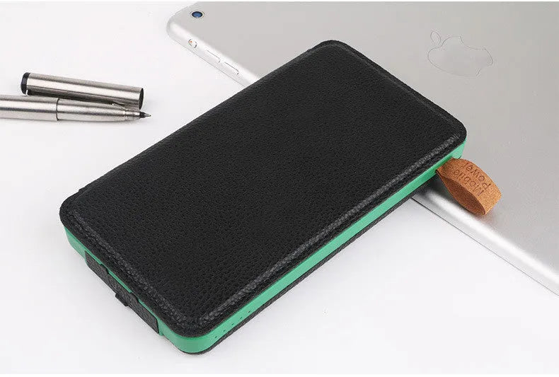 Black solar power bank with solar panel on front, LED light, and soft leather exterior.