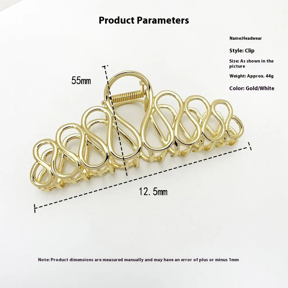 Large minimalist updo hair clip with tassel detail in gold or silver electroplated finish.