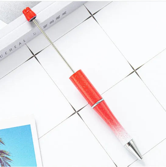 Ballpoint pen with colourful spinning plastic beads on barrel, shown in a gradient purple finish.